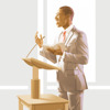 Μάρτυρας του Ιεχωβά δείχνει από τη Γραφή του σε κάποιον κύριο στη διάρκεια μιας συνάθροισης σε κάποια Αίθουσα Βασιλείας.