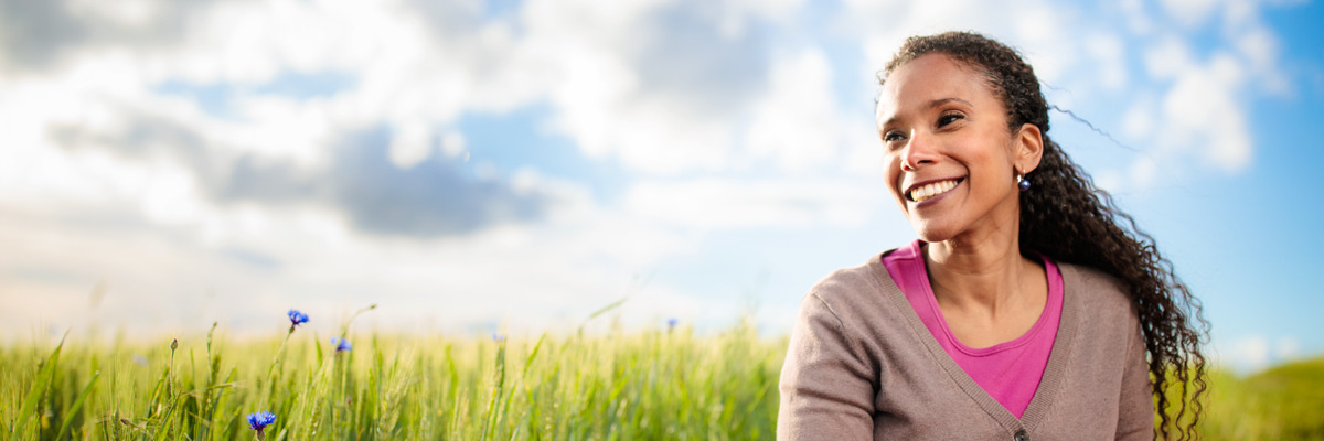 A woman enjoys a peaceful moment in a field