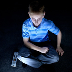A young boy watching TV