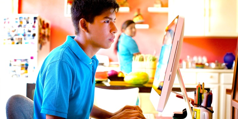 A mother observing her son surfing the Internet