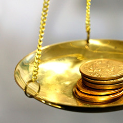 Gold coins being weighed
