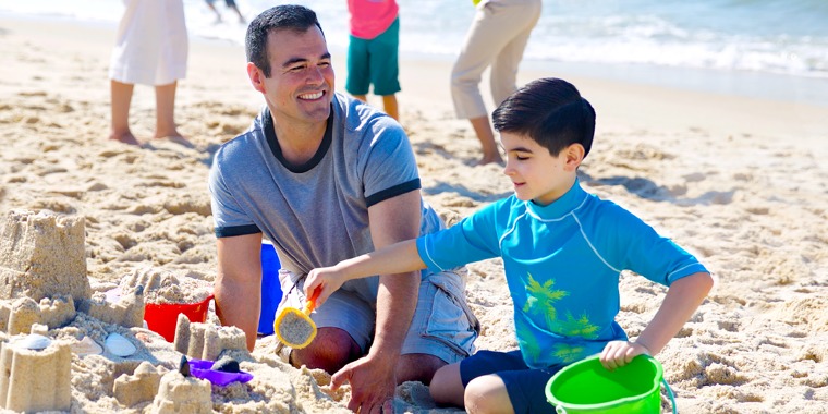 A father and son spend time together at a beach
