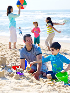 En familie bruger tid sammen på stranden