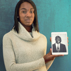 Dami holds a picture of her father