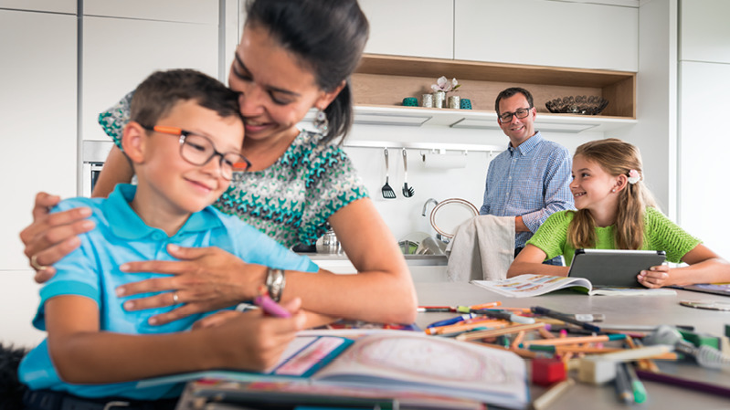 A father and mother spending time together with their young son and daughter.