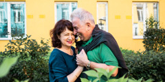 A happy older couple embracing.