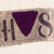 A Nazi concentration camp badge with a purple triangle.
