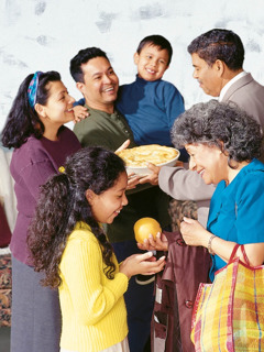 A couple shares food with a family