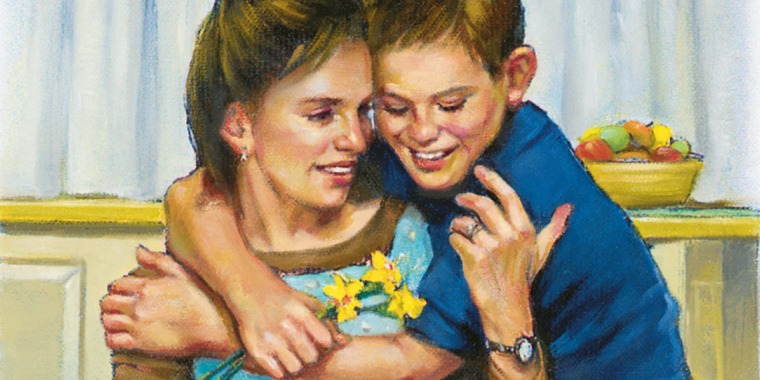 A boy hugs his mother and gives her flowers