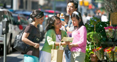 Two sisters preaching to a young woman on the street. A young man looks over to see what they are talking about.