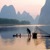 A man crosses a river on a raft