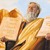 Moses holds the stone tablets containing the Ten Commandments