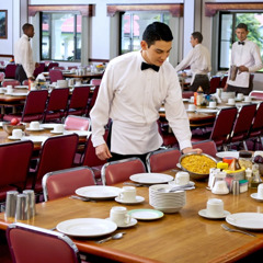 Waiters setting tables in the Bethel dining room in Colombia