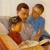 A father reading Bible stories with his son and daughter