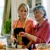 A mother-in-law looks disapprovingly at the cooking methods of her daughter-in-law