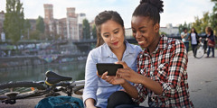 Two young women looking at a mobile device