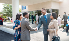 Brothers and sisters greeting one another outside a Kingdom Hall.