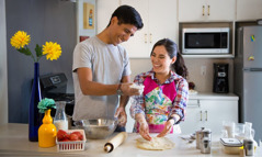 A husband and wife enjoy working together in the kitchen