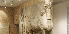 An ancient statue of a human-headed winged bull.
