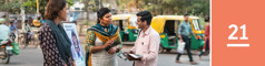 Lesson 21. A man on a city street talks with two of Jehovah’s Witnesses next to a literature cart.