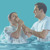 Мужчину крестят, погружая в воду.