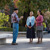 A man conversing with two sisters in a public park.