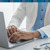 A clinician typing on a computer.