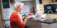 A son having a video chat with his elderly mother