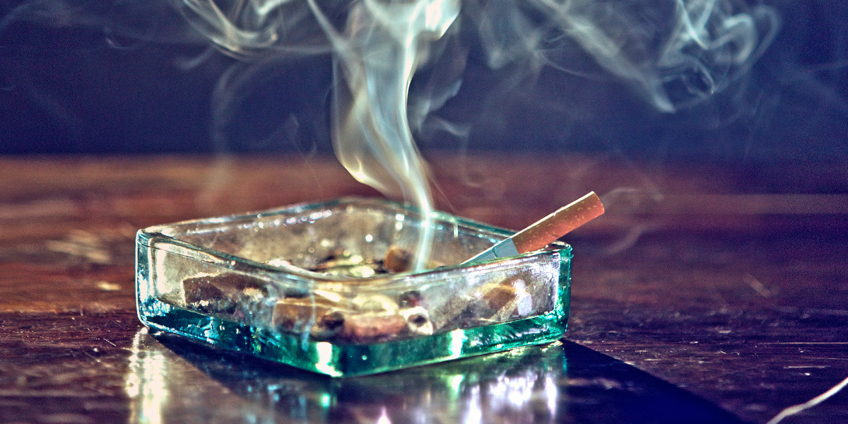 Smoke rising from a cigarette in an ashtray