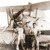 Christian brothers in front of an airplane that was used to scatter invitations