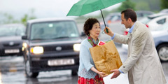 A man helping a woman with her groceries