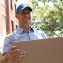 A young man on a moving crew enjoying his work