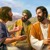Jesus smiles brightly as two of his disciples relate experiences