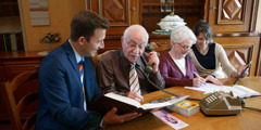 An elderly Christian brother and sister are helped by younger ones to do phone witnessing and letter writing