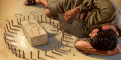 Ezekiel lies on his left side facing a brick with the city of Jerusalem engraved on it