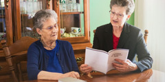 Maureen reads the daily text to her mother