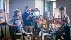 A small group of Jehovah’s Witnesses gathers for a meeting in a brother’s storeroom