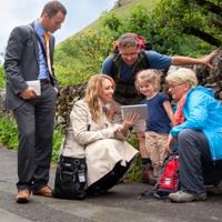 Jehovah’s Witnesses play a video for a little girl and her parents