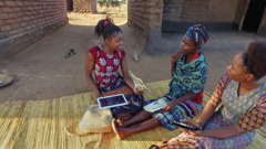 A scene from the video ‘Youths​—Taste and See That Jehovah Is Good.’ After walking two hours on foot from her home, a sister studies with a deaf girl.