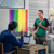 A teenage Witness respectfully explaining his beliefs to a teacher in a classroom. The classroom is decorated with rainbow flags to support gay rights.