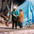 A sister wearing a hard hat, witnessing to a woman after a natural disaster.