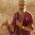 King Saul looking up and speaking while holding the cutoff edge of his sleeveless coat.