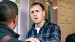 A scene from the video “Display Unfailing Love in the Ministry.” An angry householder speaks harshly to the father, who is accompanied by his son in the ministry.