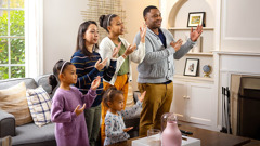 The family shown earlier standing and practicing a Kingdom song.