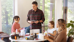 The family shown in the previous image, preparing their emergency supplies.