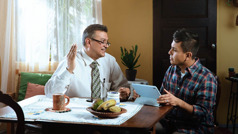 A brother conducting a Bible study with a man at his home.