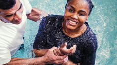 A young woman getting baptized.