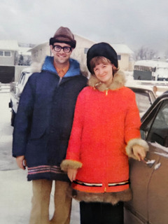 Russell and Randi beside a car on a winter day.