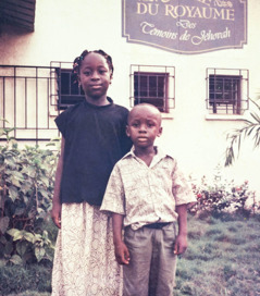 Young Jahgift and Eric in front of the Kingdom Hall.