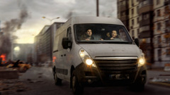 Two brothers driving a van through a war zone. Debris, smoke, and fire are behind them.